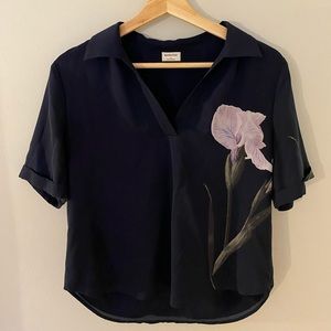 Babaton blue blouse with a violet iris flower